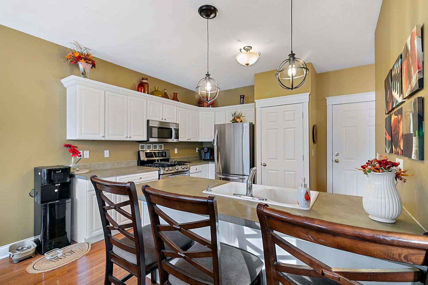 365 Cottage View Terrace Valparaiso, IN 46383 - Photo 6 of 17 a view of a dining room and kitchen with furniture wooden floor and chandelier