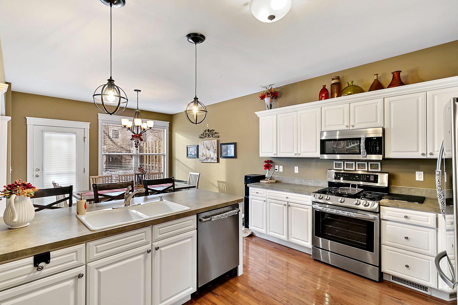 365 Cottage View Terrace Valparaiso, IN 46383 - Photo 8 of 17 a kitchen with stainless steel appliances a sink a stove and a wooden floor