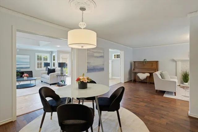 a view of a dining room with furniture wooden floor and chandelier