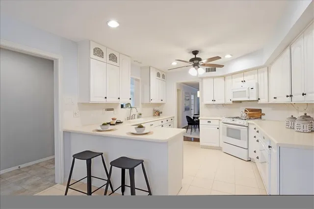 a kitchen with cabinets a sink and appliances