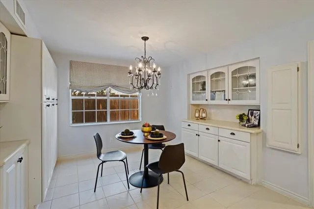 a view of a dining room with furniture and chandelier