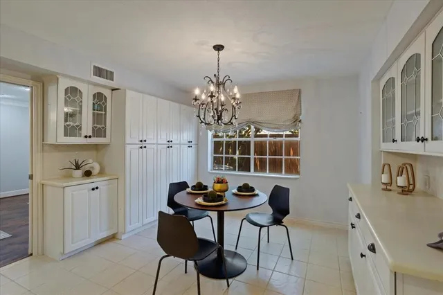 a dining room with furniture and chandelier