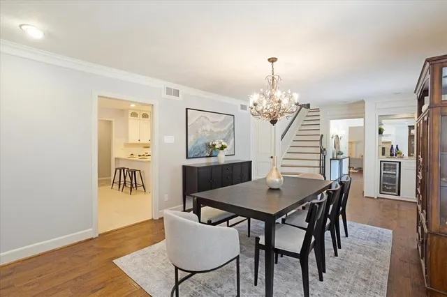 a dining room with furniture and chandelier