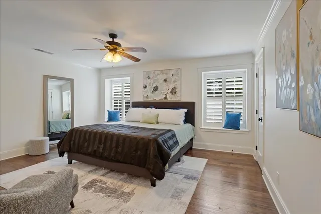 a bedroom with a large bed and a chandelier