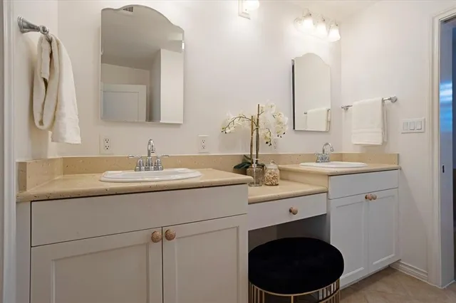a bathroom with a double vanity sink and a mirror