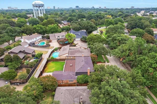 an aerial view of a house with a garden and swimming pool