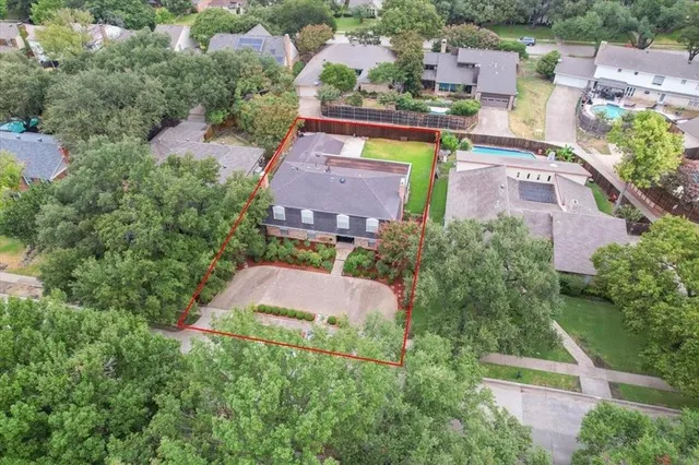 an aerial view of multiple houses with yard