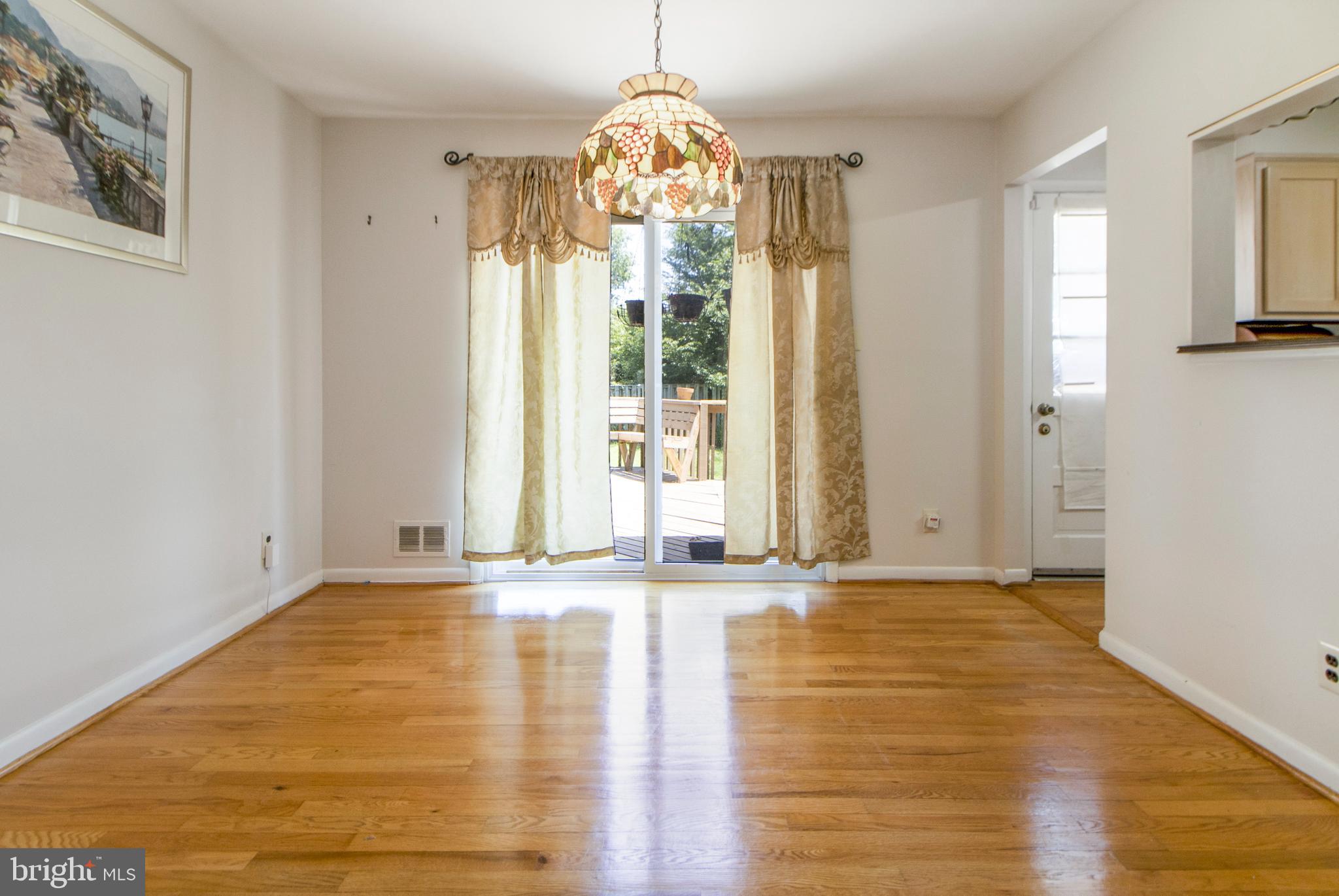 6311 Barrs Lane Lanham, MD 20706 - Photo 11 of 54 a view of an empty room with window and wooden floor