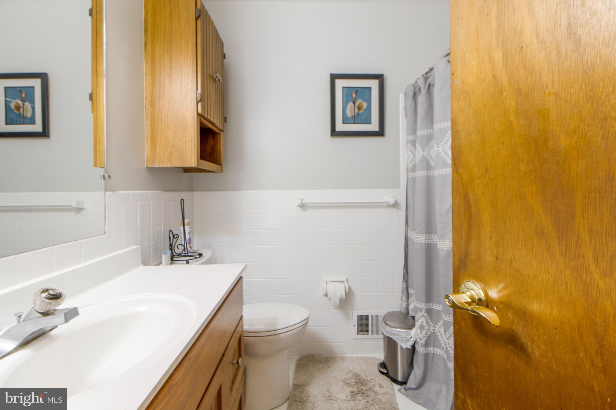 6311 Barrs Lane Lanham, MD 20706 - Photo 13 of 54 a bathroom with a sink and a toilet