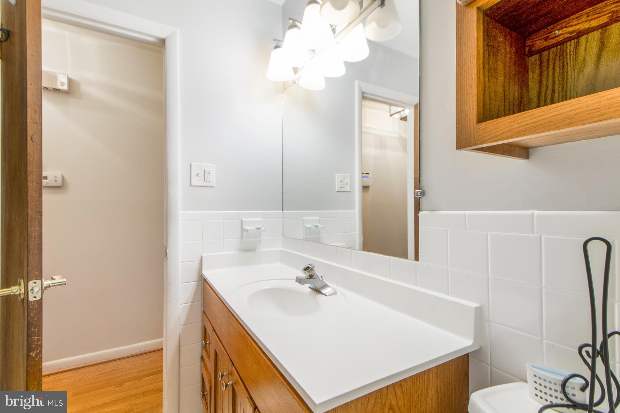 6311 Barrs Lane Lanham, MD 20706 - Photo 16 of 54 a bathroom with a sink vanity and a mirror