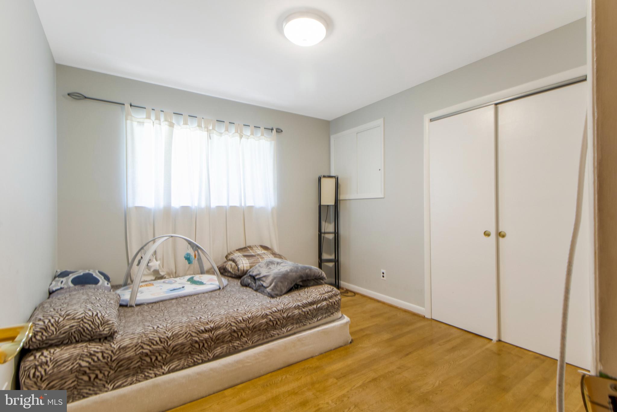 6311 Barrs Lane Lanham, MD 20706 - Photo 17 of 54 a bedroom with a bed and a window