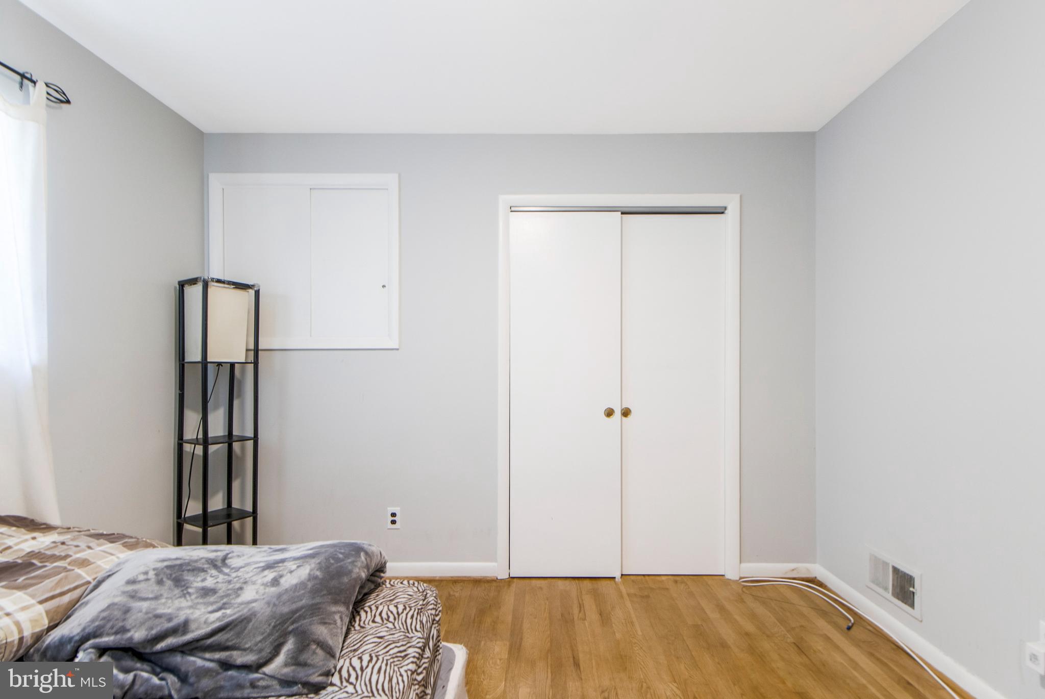 6311 Barrs Lane Lanham, MD 20706 - Photo 18 of 54 a bedroom with a bed and a window