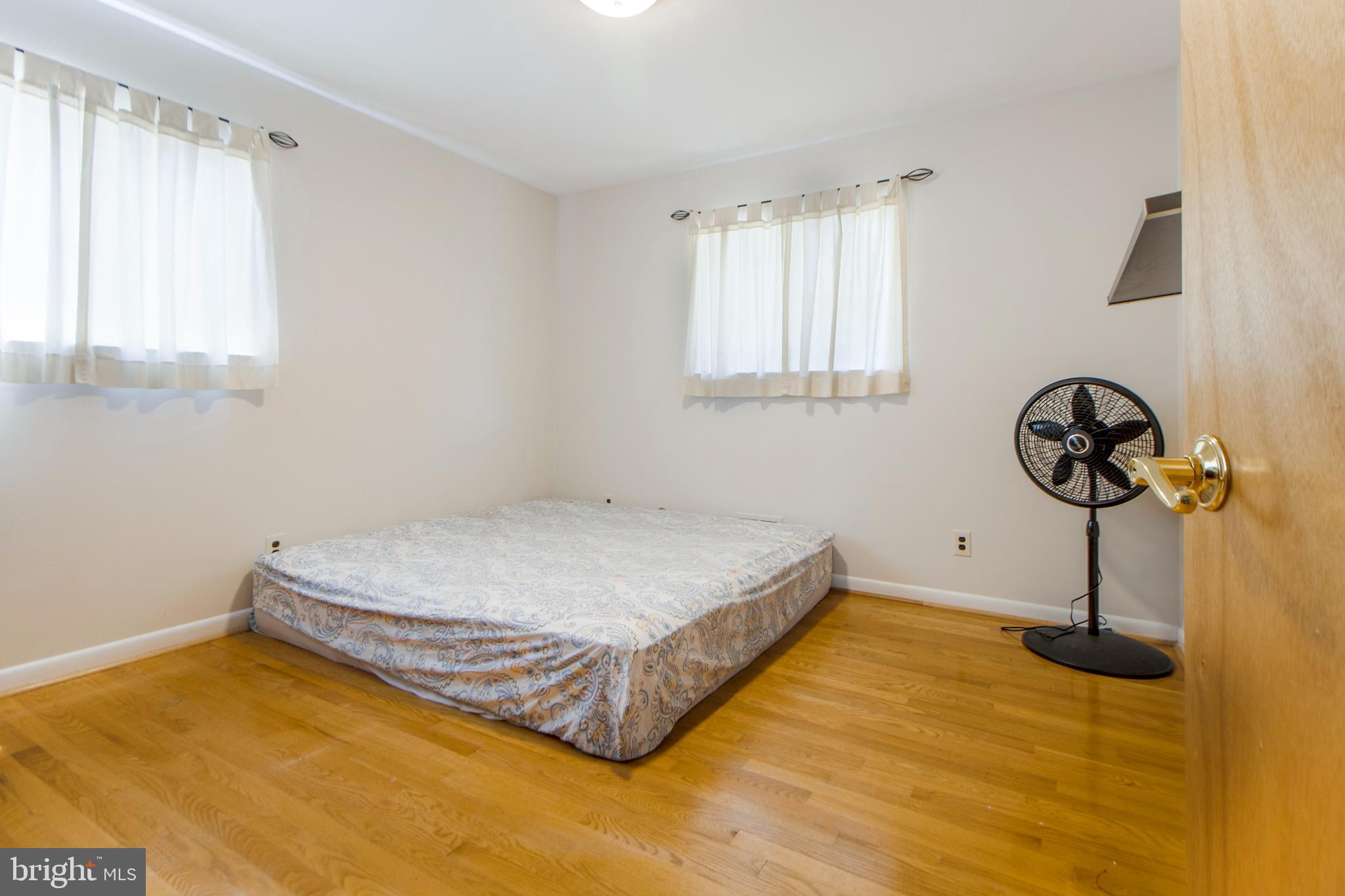 6311 Barrs Lane Lanham, MD 20706 - Photo 19 of 54 a bedroom with a bed and a window