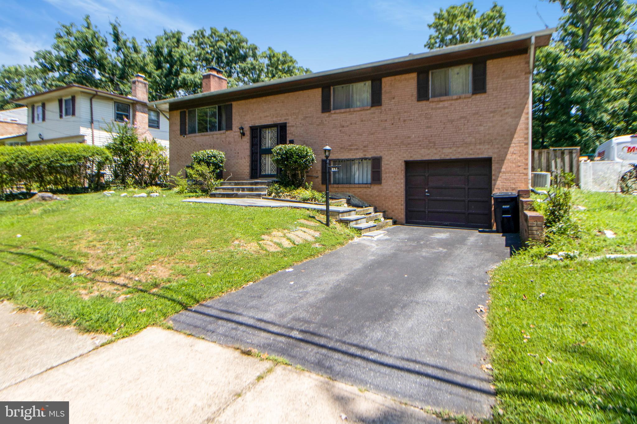 6311 Barrs Lane Lanham, MD 20706 - Photo 24 of 54 a front view of a house with garden