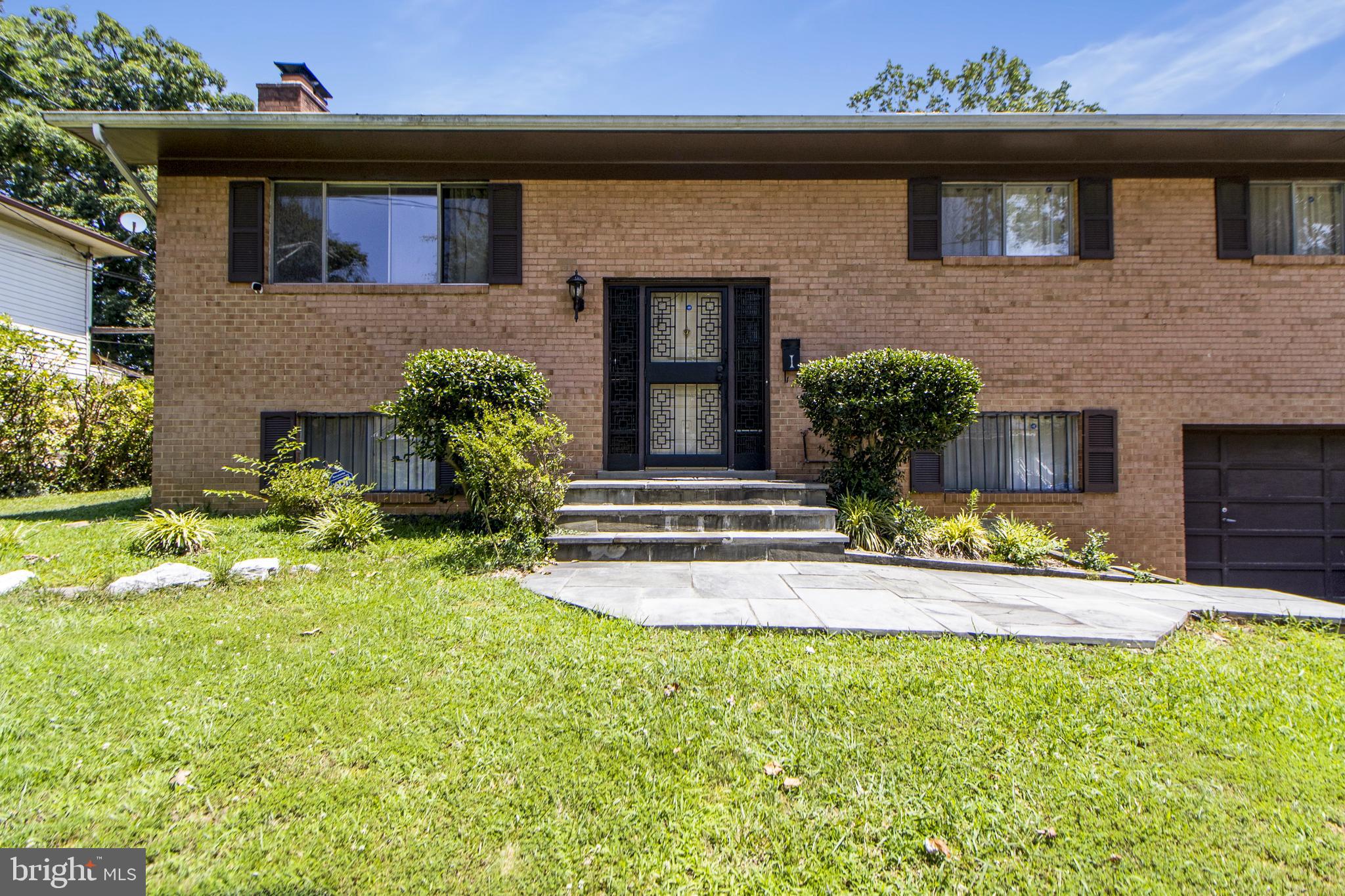 6311 Barrs Lane Lanham, MD 20706 - Photo 25 of 54 a front view of a house with a yard