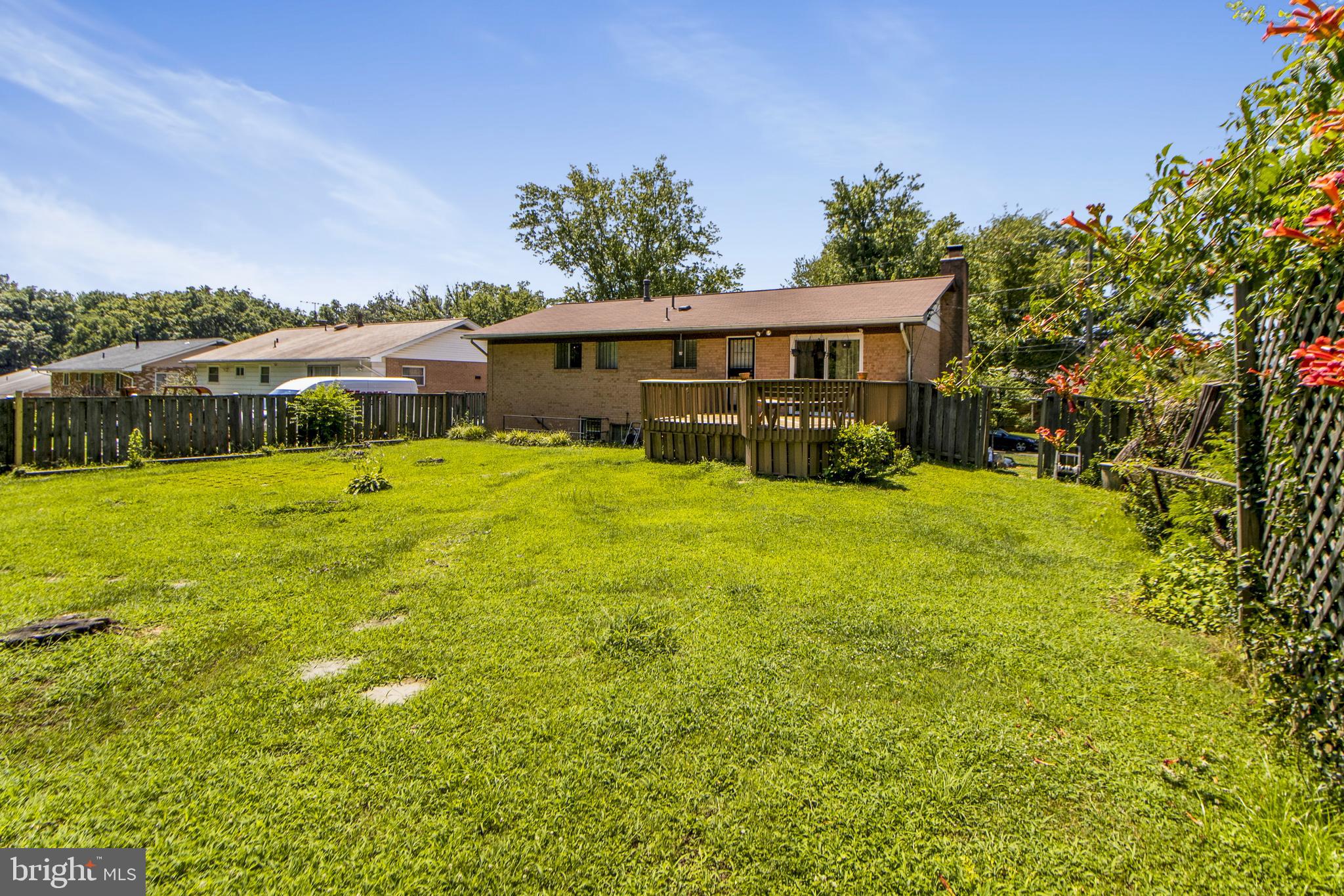 6311 Barrs Lane Lanham, MD 20706 - Photo 27 of 54 a view of a house with a yard and sitting area