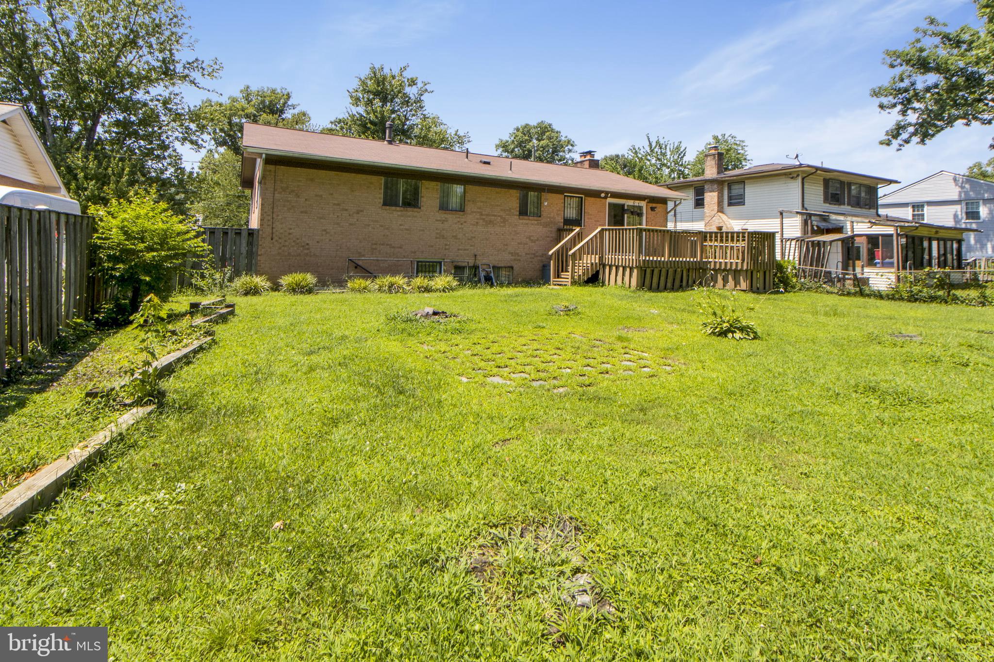 6311 Barrs Lane Lanham, MD 20706 - Photo 29 of 54 a front view of a house with a yard table and chairs