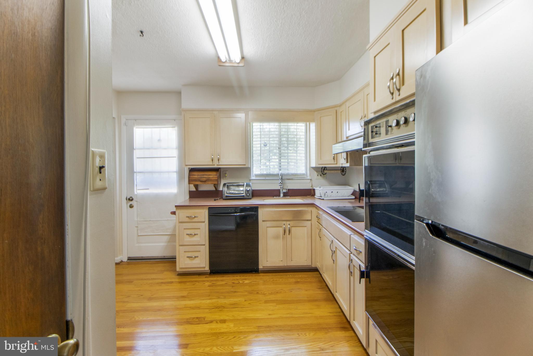 6311 Barrs Lane Lanham, MD 20706 - Photo 4 of 54 a kitchen with stainless steel appliances granite countertop a stove a sink and a refrigerator