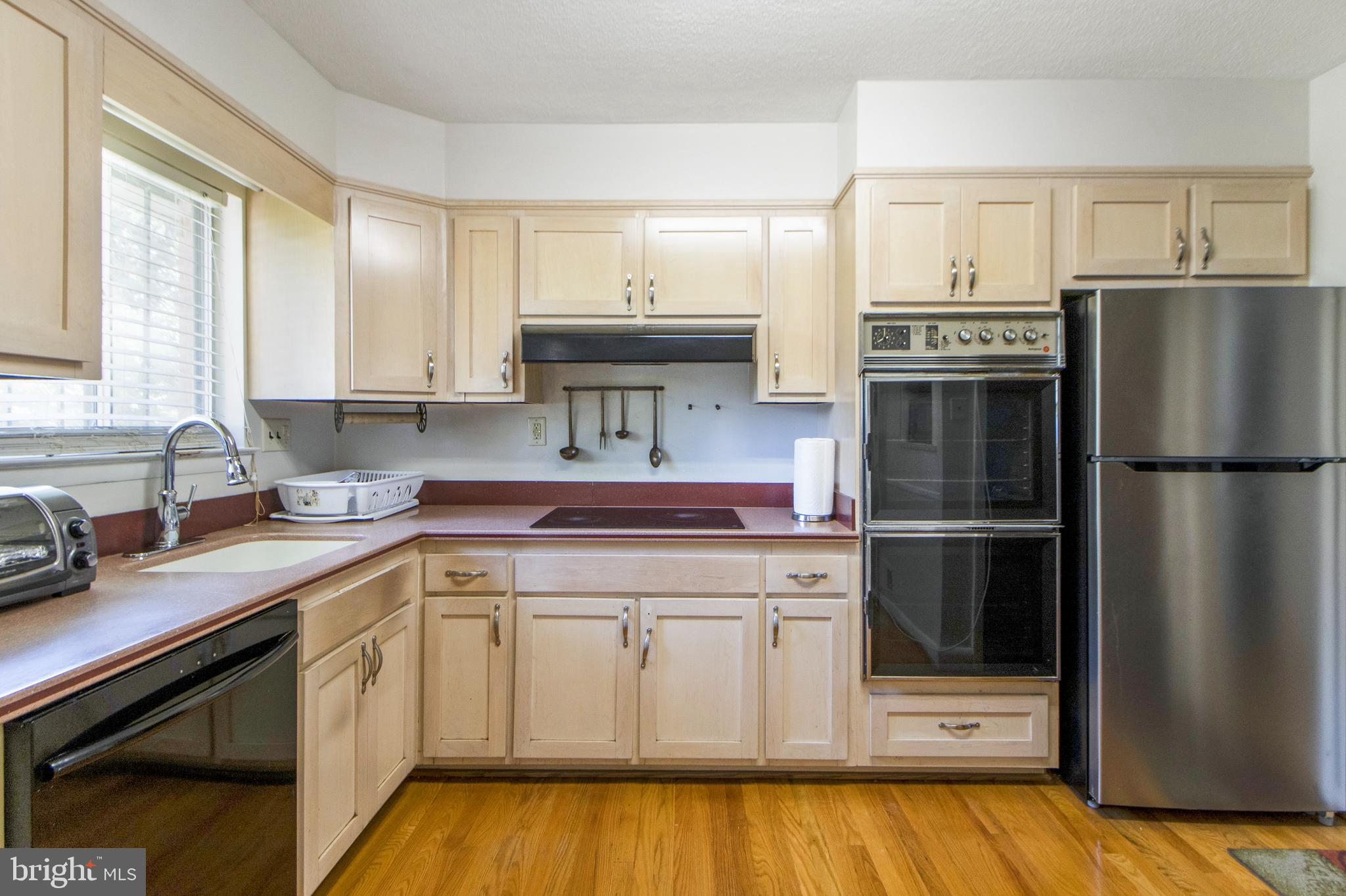 6311 Barrs Lane Lanham, MD 20706 - Photo 5 of 54 a kitchen with a refrigerator sink and stove
