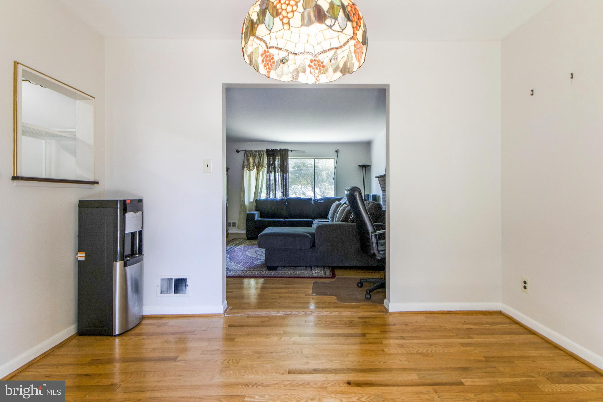 6311 Barrs Lane Lanham, MD 20706 - Photo 9 of 54 a living room with furniture and a fireplace