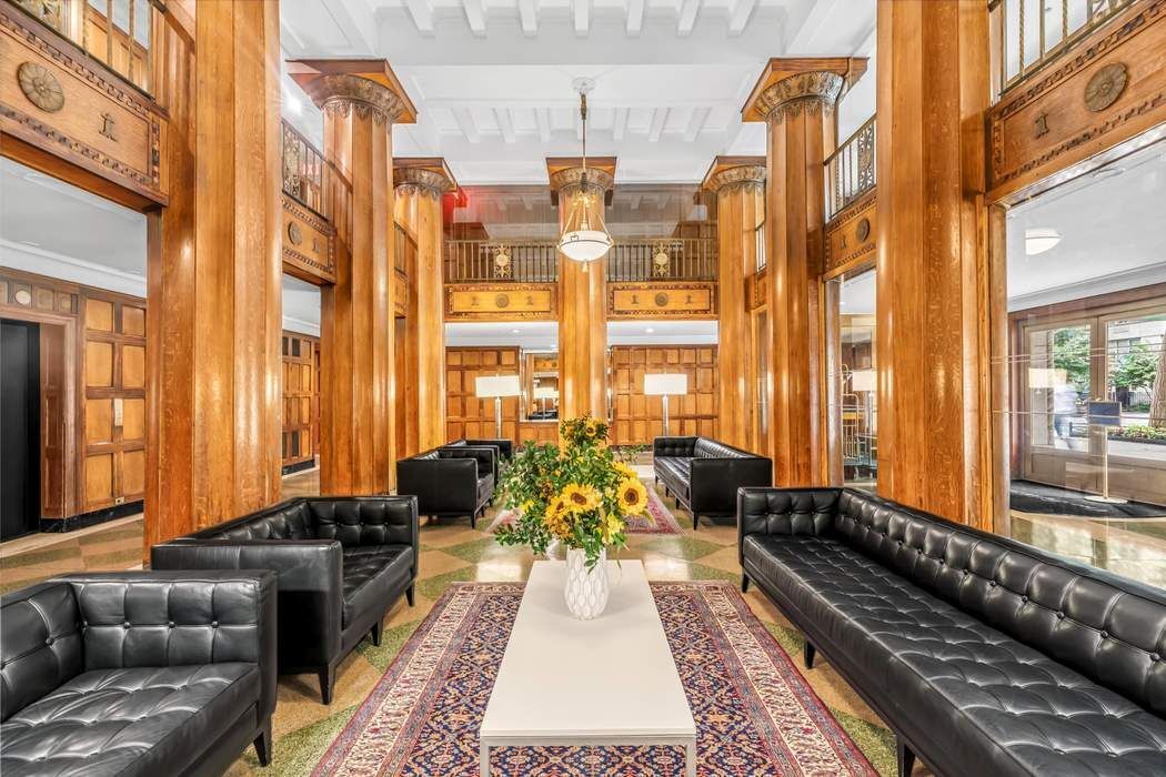 1 5th Avenue, Unit 2J Manhattan, NY 10003 - Photo 14 of 19 a living room with furniture and a large window