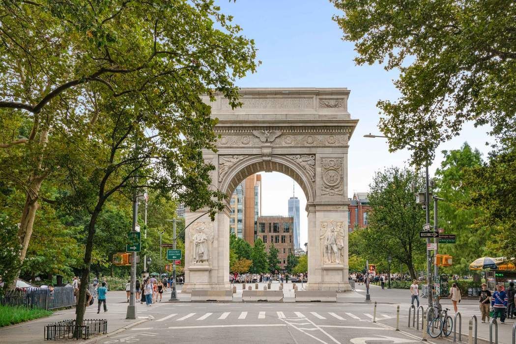 1 5th Avenue, Unit 2J Manhattan, NY 10003 - Photo 18 of 19 a view of a brick house with a clock tower in front of it