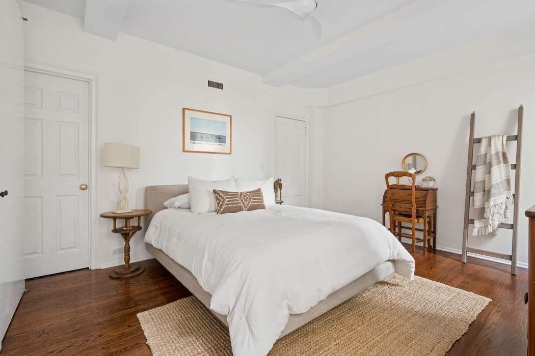 1 5th Avenue, Unit 2J Manhattan, NY 10003 - Photo 8 of 19 a bedroom with bed and wooden floor