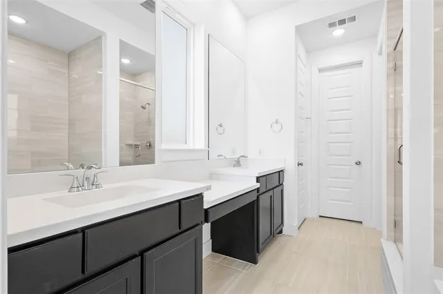 a bathroom with a tub sink and mirror