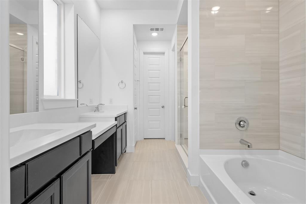 1136 Saddle Ridge Drive Aubrey, TX 76227 - Photo 13 of 26 a bathroom with a tub sink and mirror