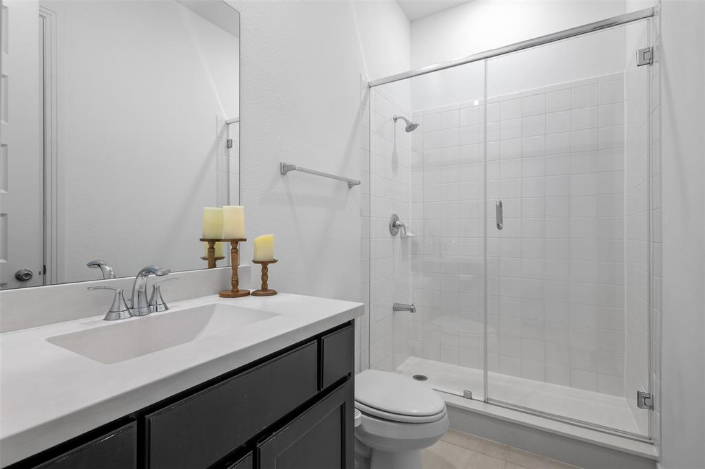 1136 Saddle Ridge Drive Aubrey, TX 76227 - Photo 14 of 26 a bathroom with a sink a toilet and shower