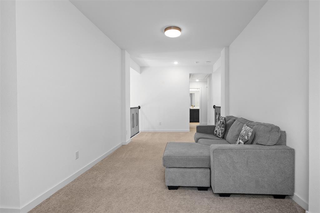 1136 Saddle Ridge Drive Aubrey, TX 76227 - Photo 17 of 26 a living room with furniture and a couch