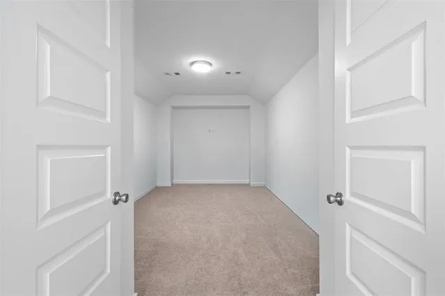 a room with wooden floor and windows