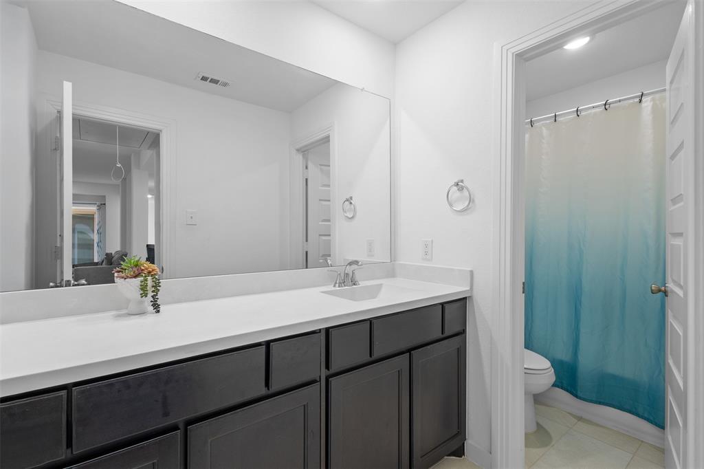 1136 Saddle Ridge Drive Aubrey, TX 76227 - Photo 20 of 26 a bathroom with a sink and a mirror