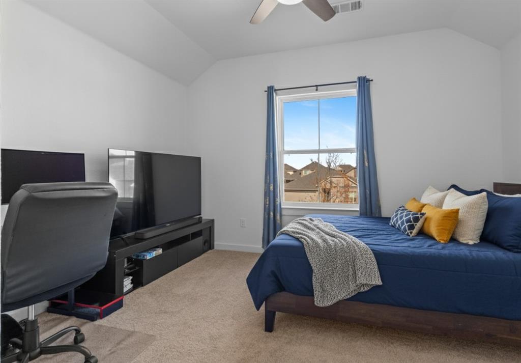 1136 Saddle Ridge Drive Aubrey, TX 76227 - Photo 21 of 26 a bedroom with a bed and window