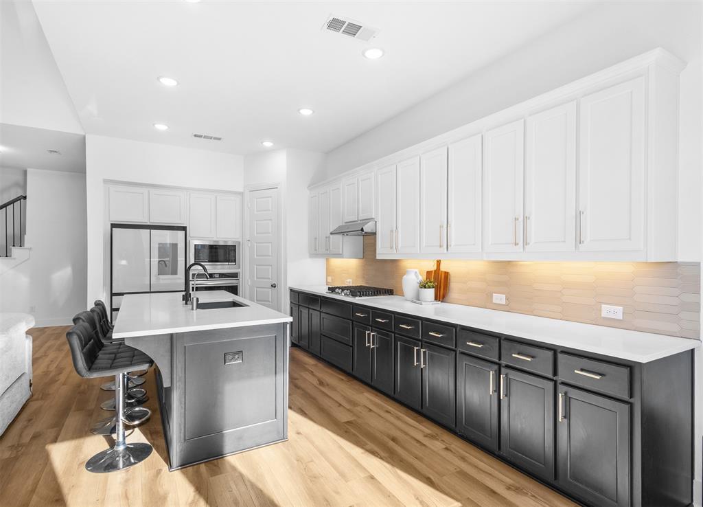 1136 Saddle Ridge Drive Aubrey, TX 76227 - Photo 4 of 26 a kitchen with stainless steel appliances sink refrigerator and cabinets
