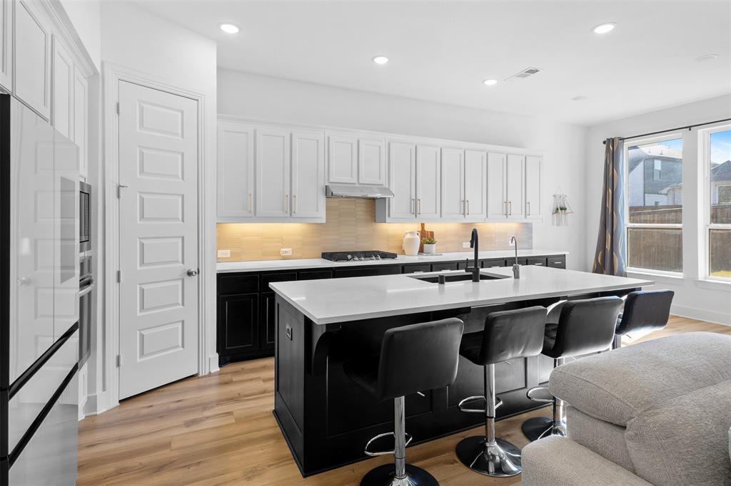 1136 Saddle Ridge Drive Aubrey, TX 76227 - Photo 5 of 26 a kitchen with a sink appliances and cabinets