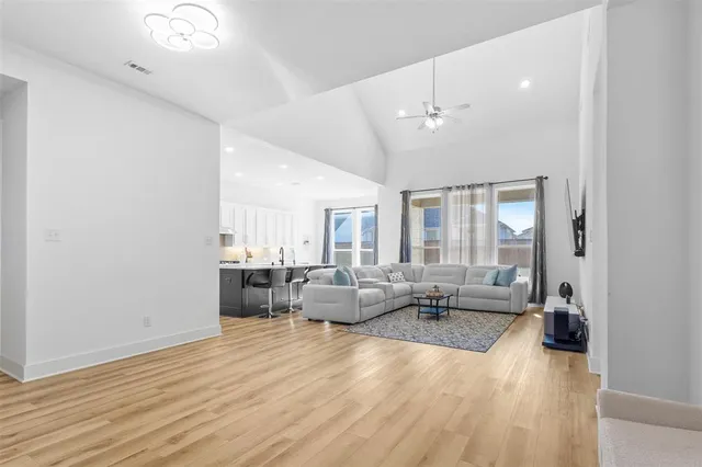 a living room with furniture and wooden floor