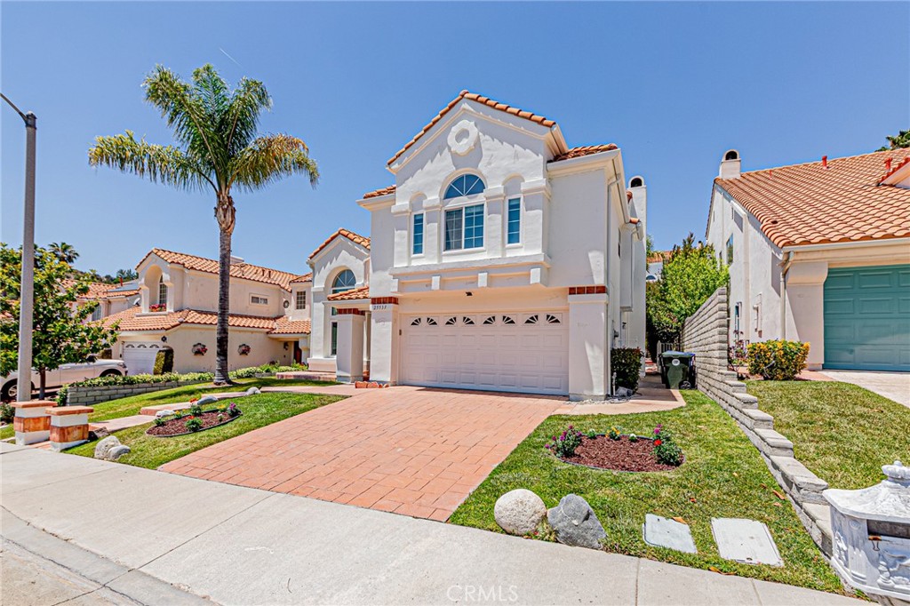 25533 Longfellow Place Stevenson Ranch, CA 91381 - Photo 37 of 47 a front view of house with yard and trees around