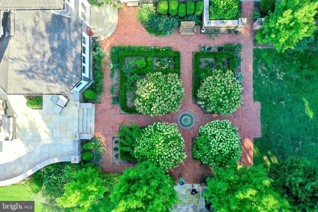 a living room with furniture a dining table and a chandelier