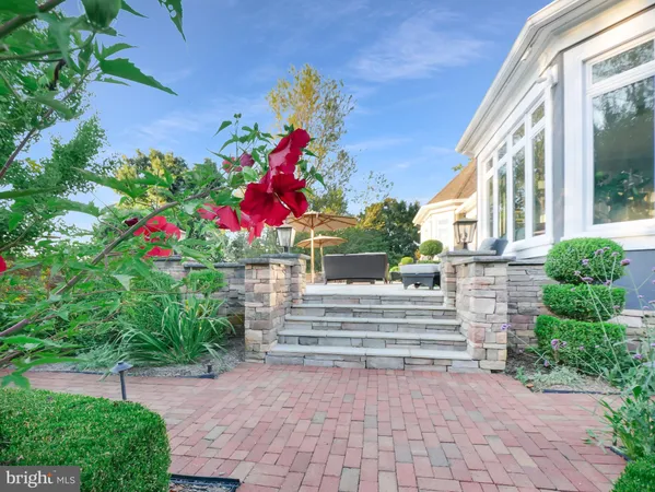a living room with furniture a fireplace and a large window