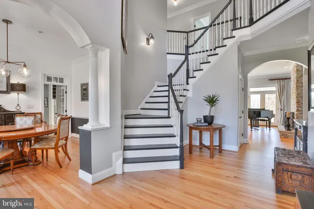 a large kitchen with stainless steel appliances granite countertop a stove a sink a oven and a dining table with the view