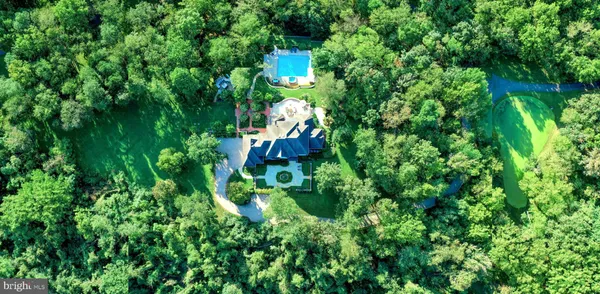 a view of a swimming pool with a yard