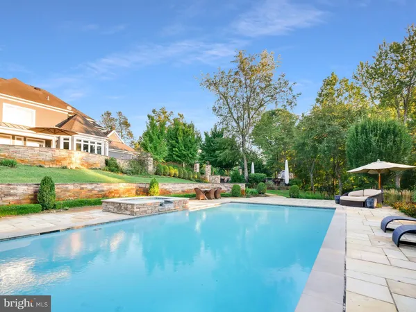 an aerial view of a house with swimming pool and porch with furniture