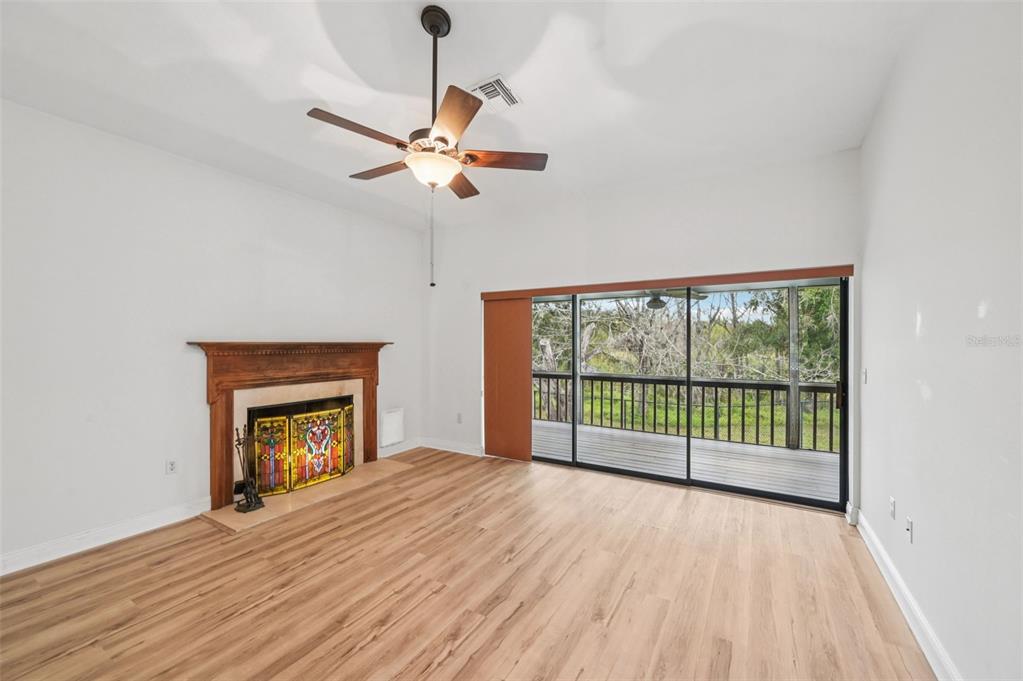 13221 North Branch Road Sarasota, FL 34240 - Photo 11 of 64 wooden floor fireplace and windows in an empty room