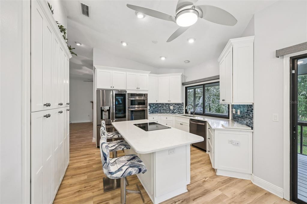 13221 North Branch Road Sarasota, FL 34240 - Photo 15 of 64 a kitchen with stainless steel appliances kitchen island granite countertop a refrigerator and a stove top oven