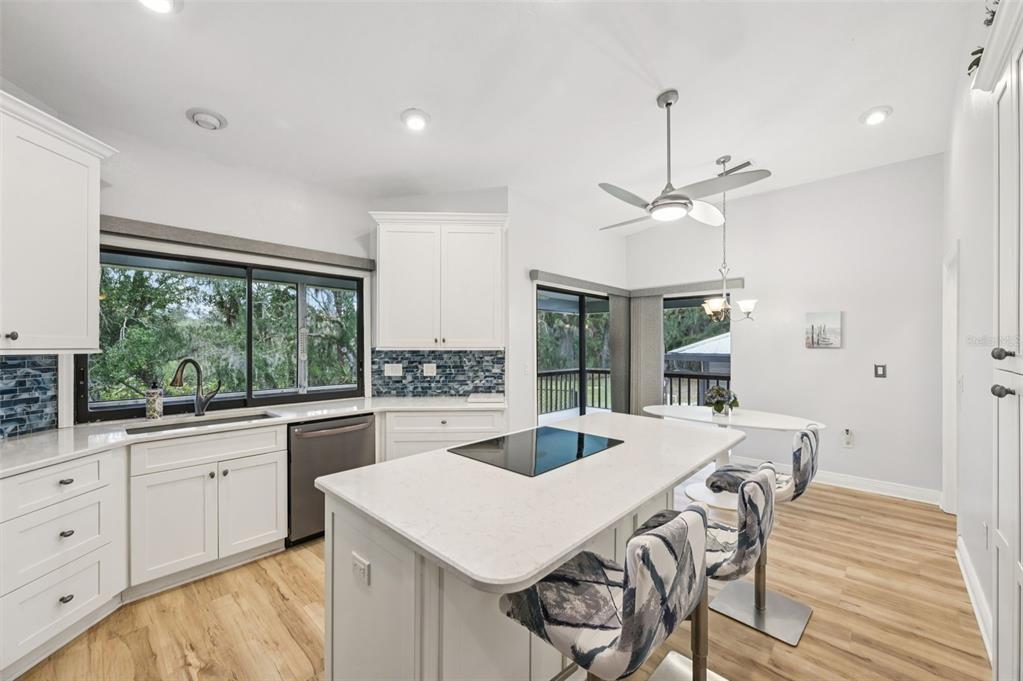 13221 North Branch Road Sarasota, FL 34240 - Photo 16 of 64 a kitchen with a table chairs and wooden floor
