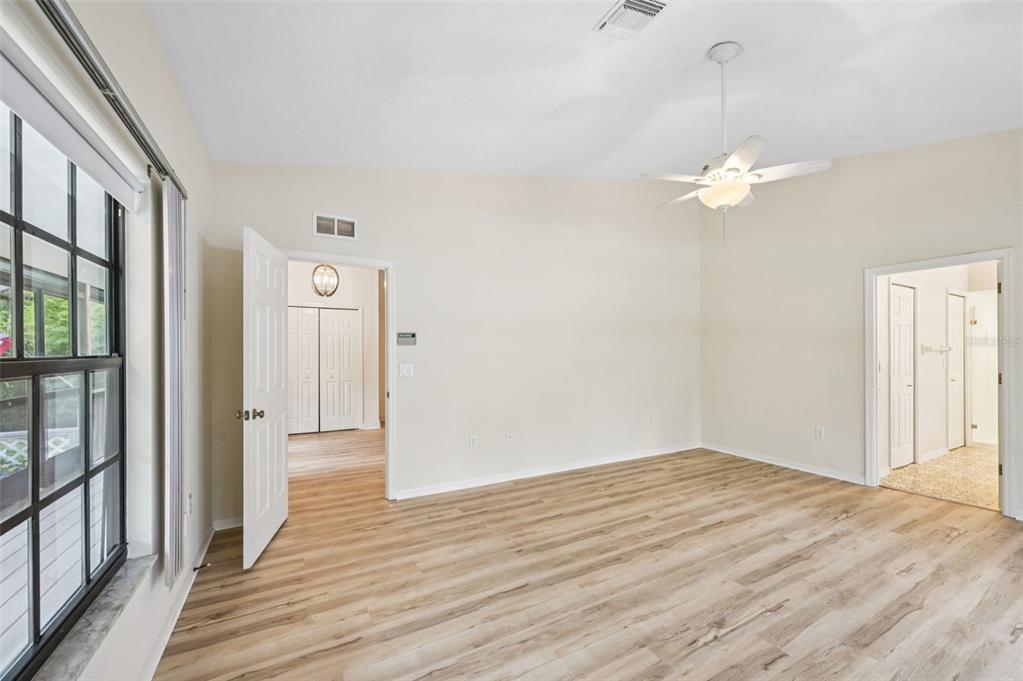 13221 North Branch Road Sarasota, FL 34240 - Photo 25 of 64 a view of empty room with wooden floor and fan