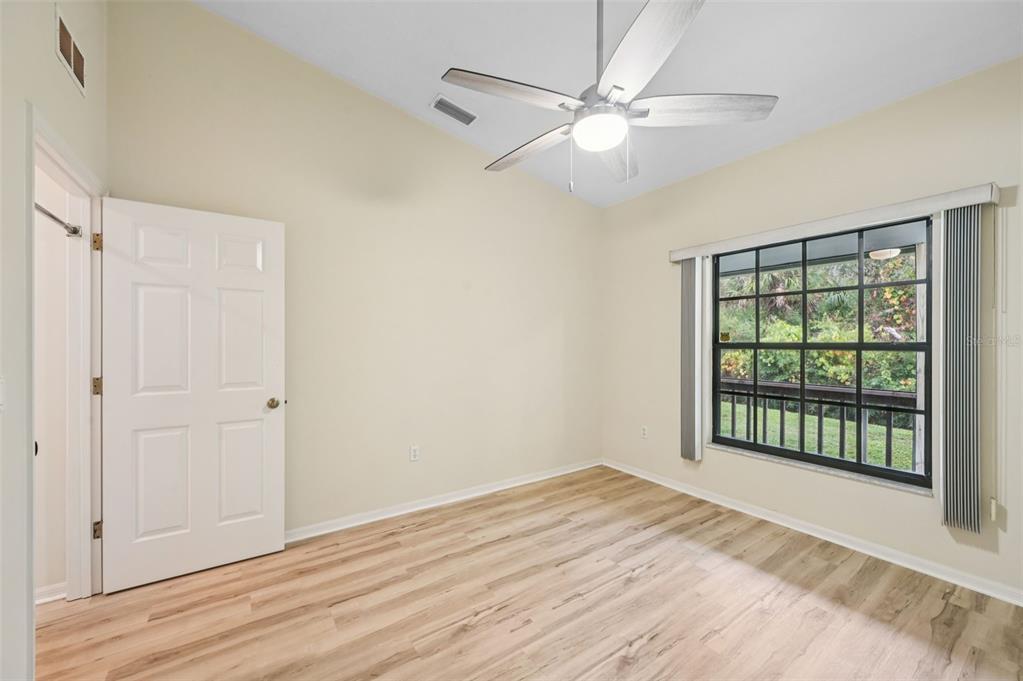 13221 North Branch Road Sarasota, FL 34240 - Photo 30 of 64 an empty room with wooden floor fan and windows