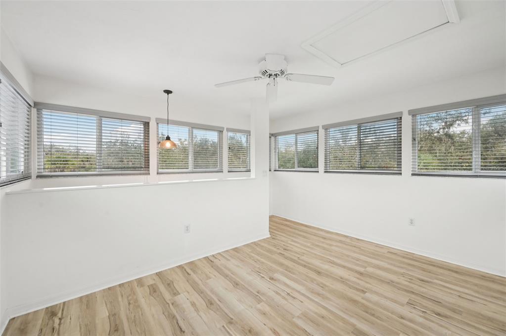13221 North Branch Road Sarasota, FL 34240 - Photo 37 of 64 an empty room with wooden floor and windows
