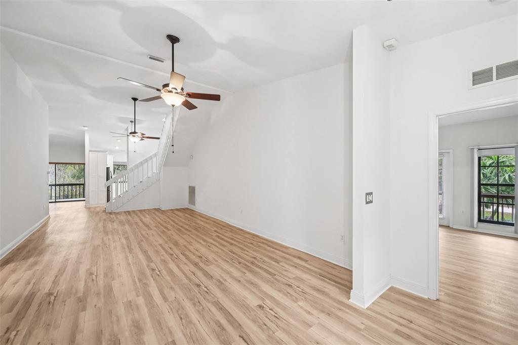 13221 North Branch Road Sarasota, FL 34240 - Photo 7 of 64 a view of a room with wooden floor ceiling fan and window